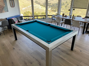 technician leveling a pool table in a Sacramento living room